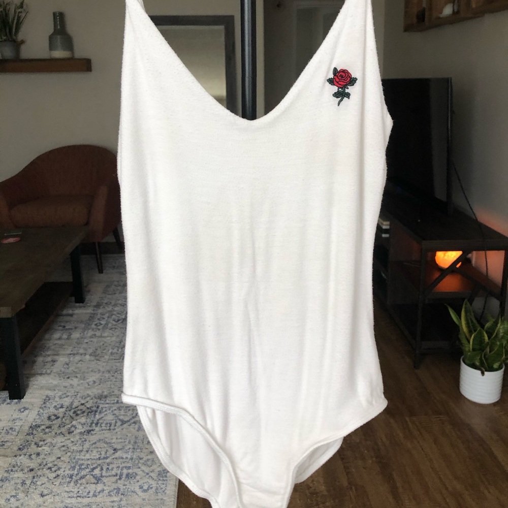 White body suit with embroidered flower